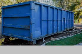 Picture Of A Blue Dumpster Being Dropped Off And Ready To Be Filled
