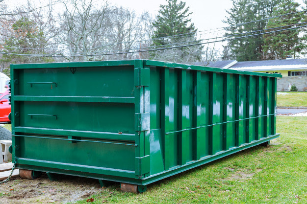 A Picture Of A Green Dumpster That Was Dropped Of A Customers House In Omaha Before Being Filled By The Customer