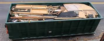 A Picture Of A Green Roll Off Dumpster With Trash Filled To The Top Packed Nicely With Construction Debris